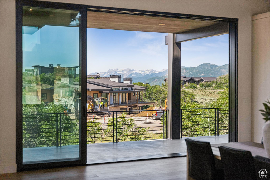 Entryway featuring a mountain view, wood finished floors, and floor to ceiling windows