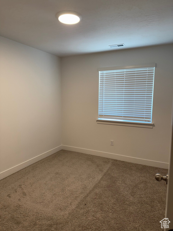 Unfurnished room with carpet floors and baseboards