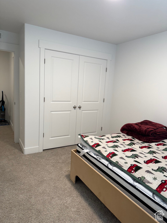 Bedroom with carpet floors and a closet