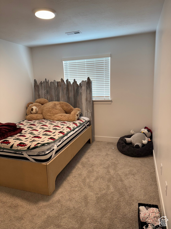 Bedroom with carpet floors and baseboards