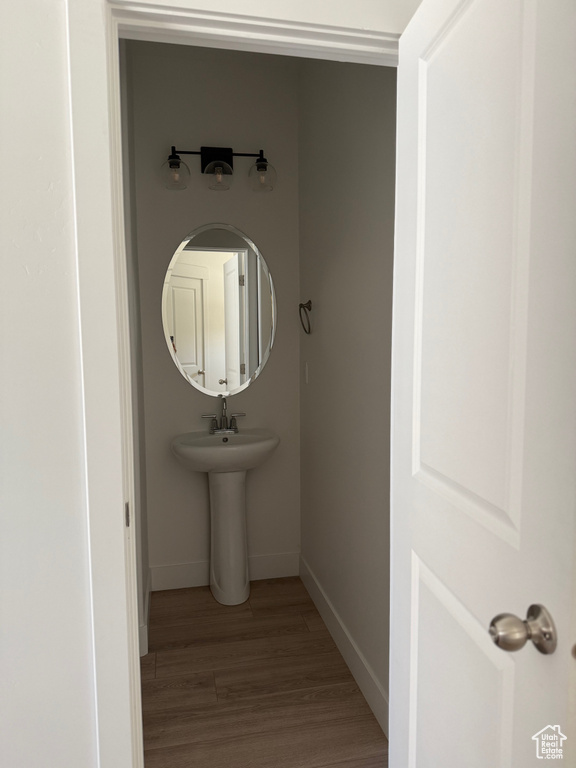 Bathroom featuring wood finished floors and baseboards