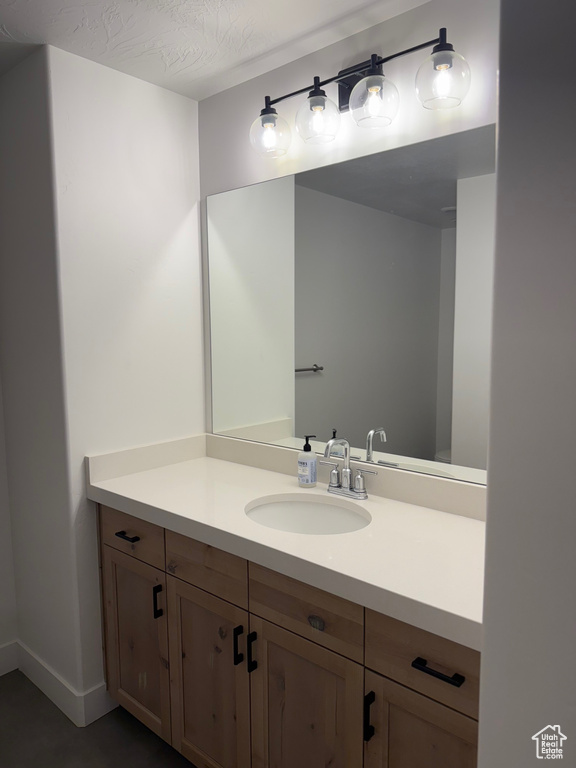 Bathroom with vanity and baseboards