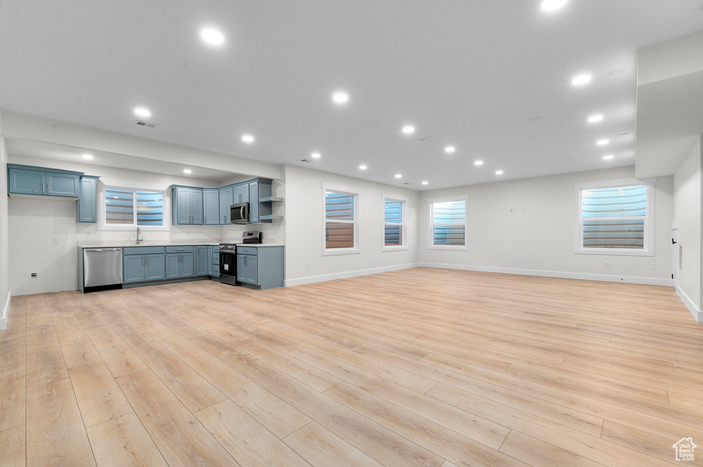 Unfurnished living room with light wood-style flooring and recessed lighting