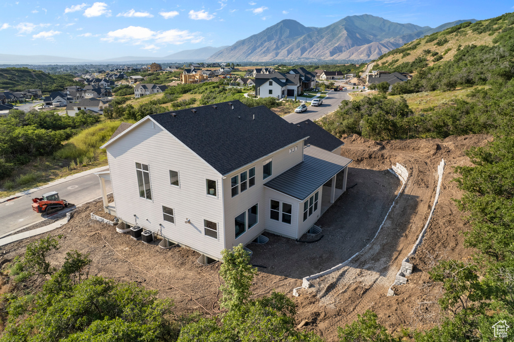 Aerial view of residential area featuring a mountainous background