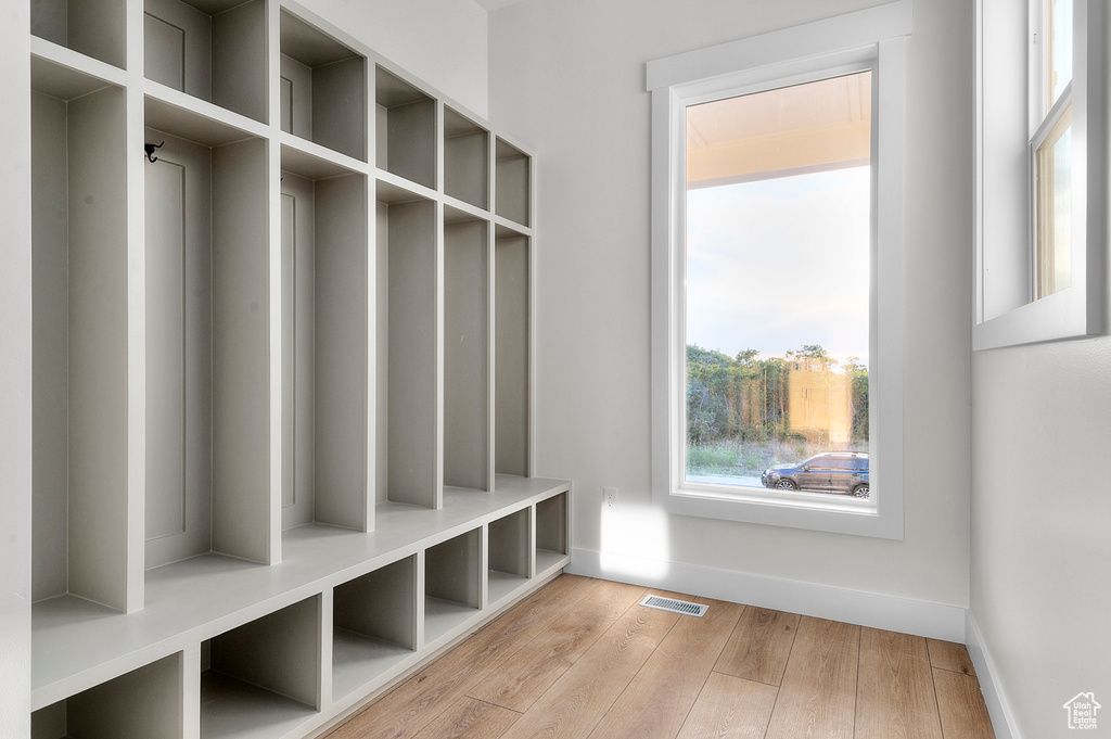 Mudroom featuring wood finished floors and baseboards
