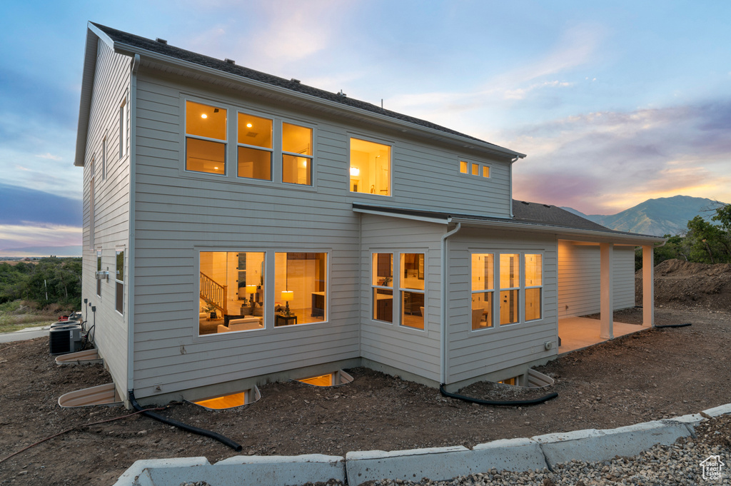 View of back of property at dusk
