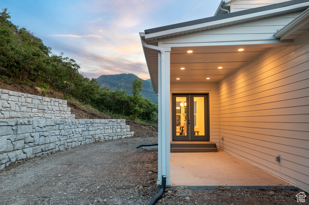 Exterior entry at dusk with a mountain view