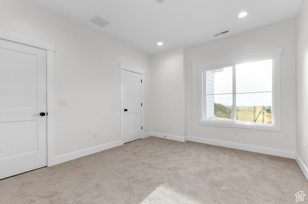 Unfurnished bedroom with carpet and recessed lighting