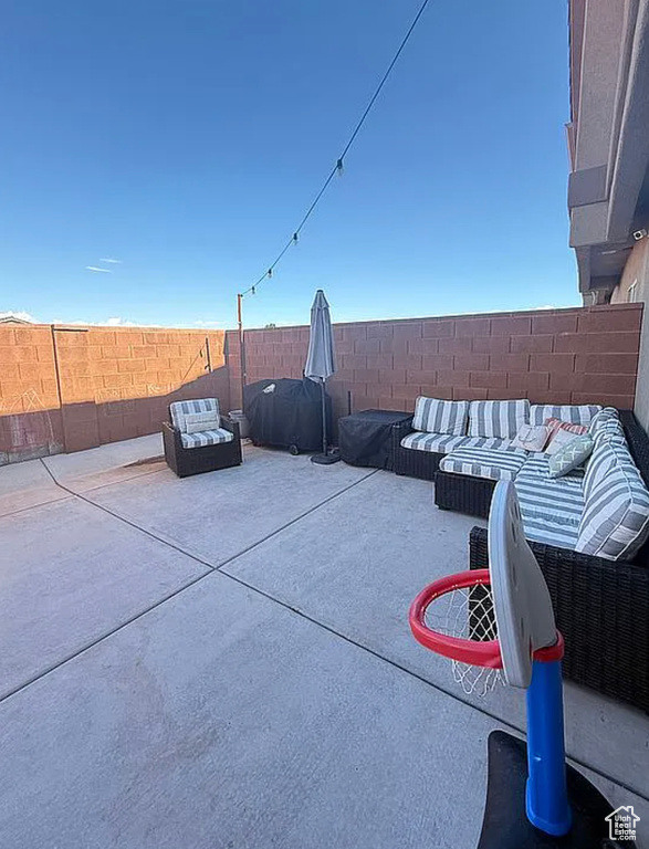 Fenced backyard featuring a patio area and an outdoor hangout area
