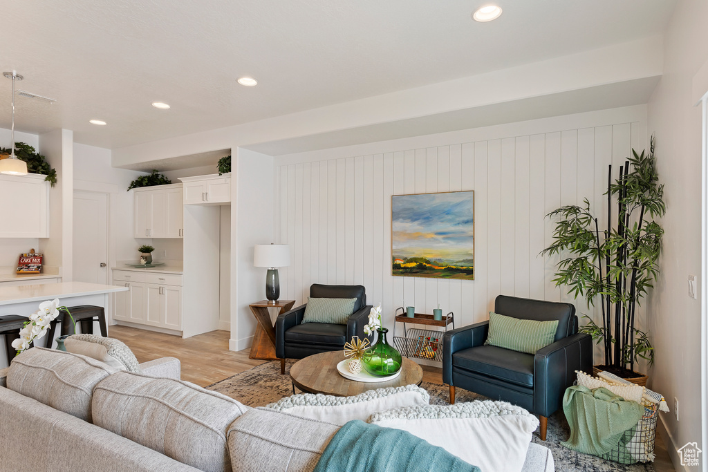 Living area featuring light wood finished floors and recessed lighting