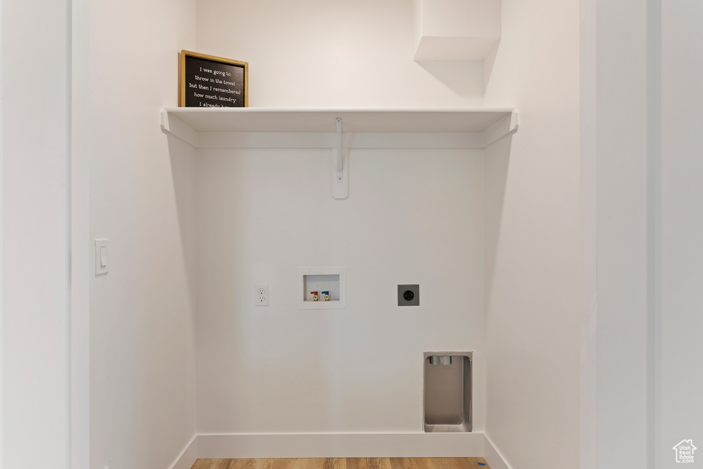 Laundry room featuring hookup for a washing machine, light wood finished floors, and electric dryer hookup