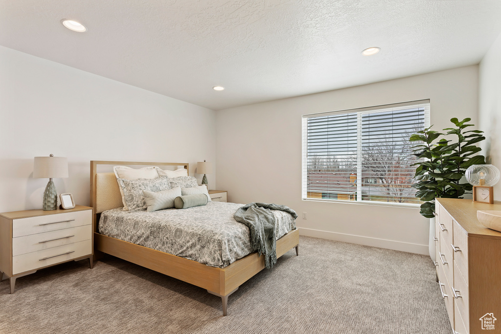 Bedroom featuring light colored carpet and recessed lighting