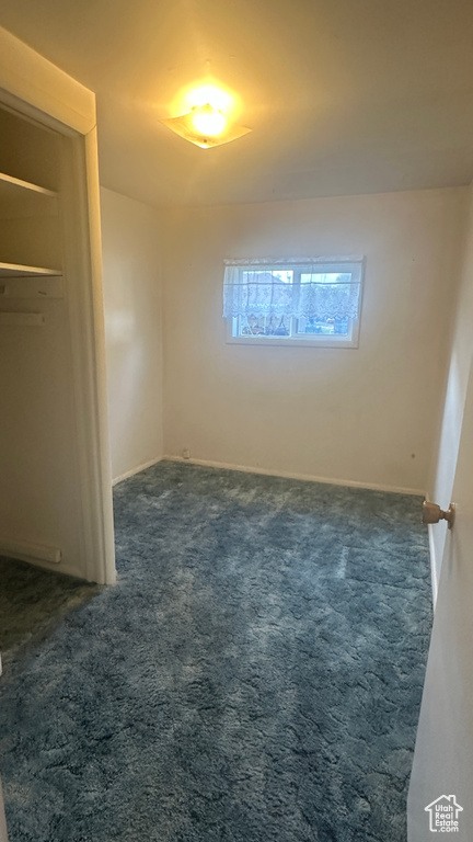Unfurnished bedroom with carpet and baseboards
