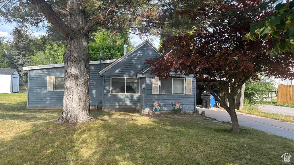 View of front of home with a storage unit