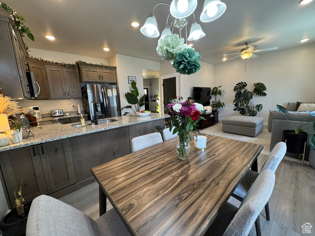 Dining room featuring a ceiling fan, light wood finished floors, and recessed lighting