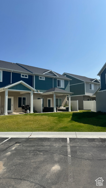 View of front of house featuring board and batten siding and uncovered parking