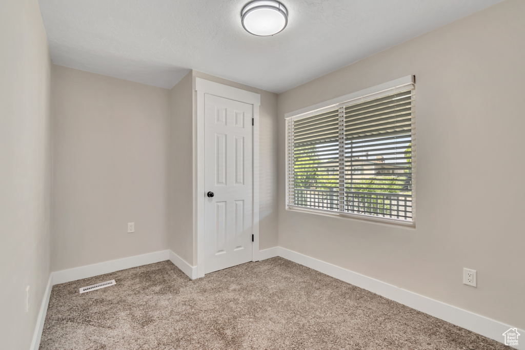 Unfurnished bedroom featuring carpet floors and a closet