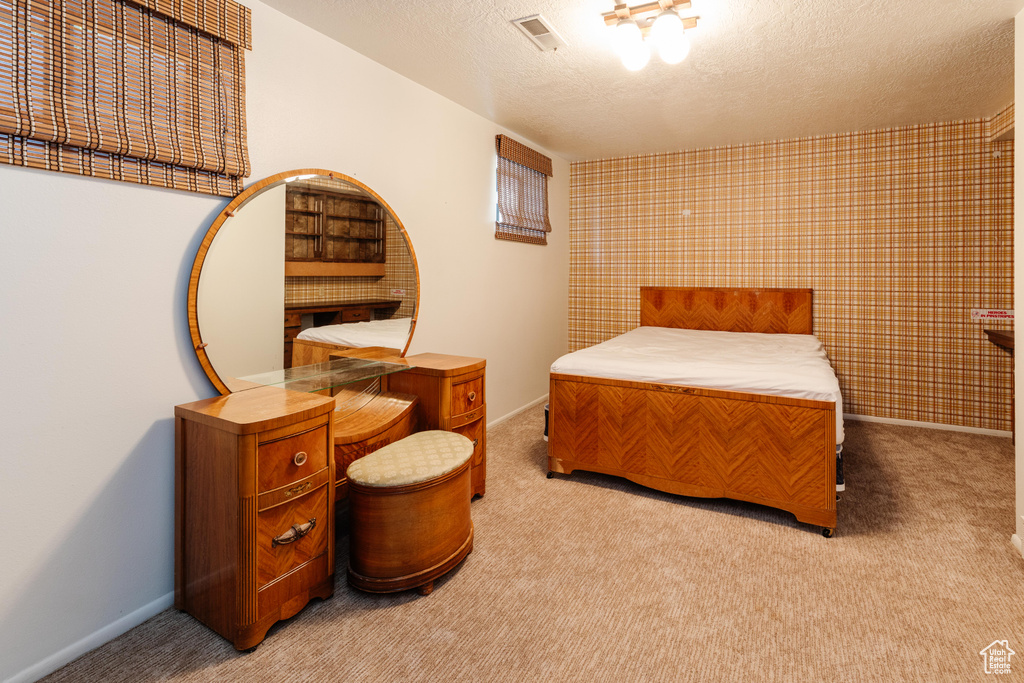 Bedroom featuring carpet flooring and a textured ceiling
