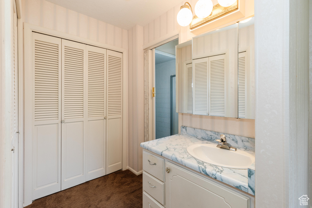 Bathroom featuring a closet and vanity