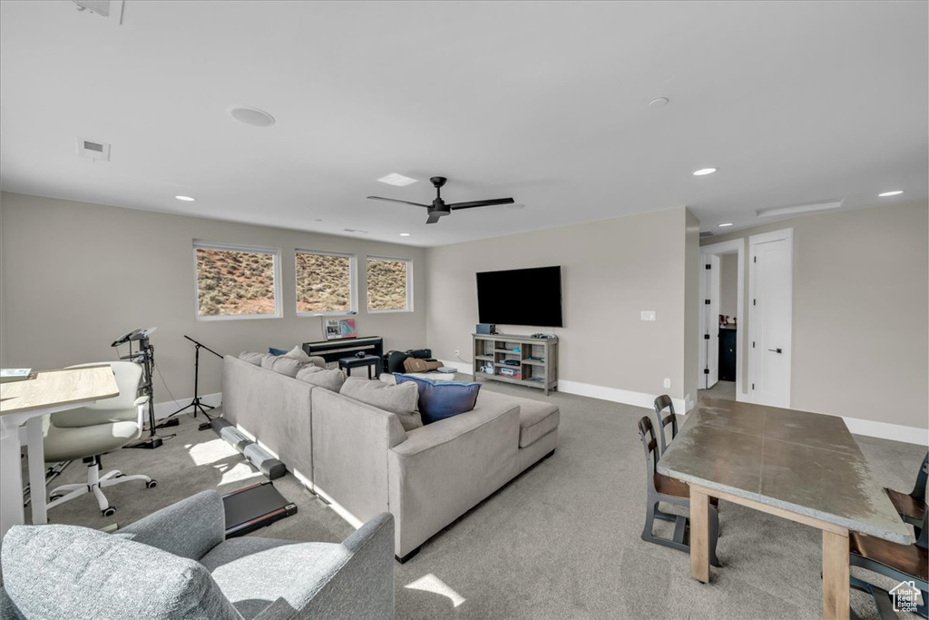 Living area featuring recessed lighting, a ceiling fan, and carpet floors