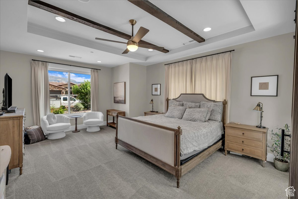 Bedroom with light colored carpet, a tray ceiling, recessed lighting, and ceiling fan