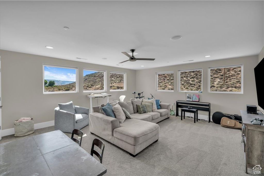 Living room with ceiling fan, carpet, and recessed lighting