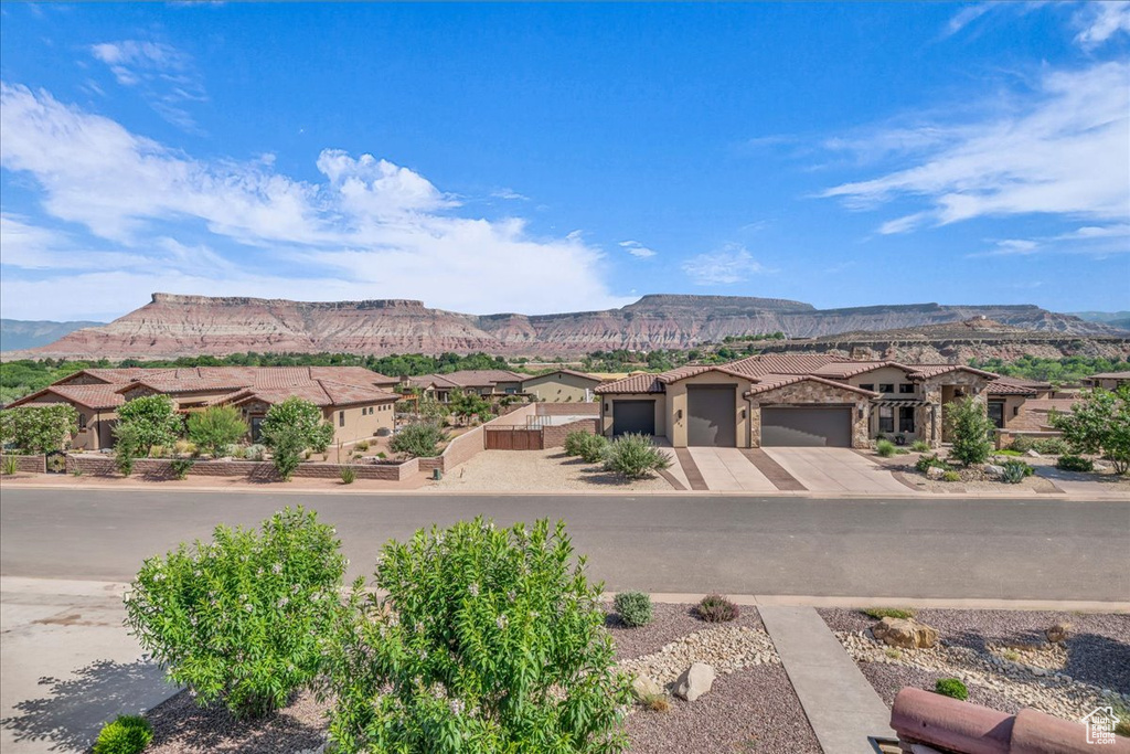 View of mountain backdrop featuring nearby suburban area