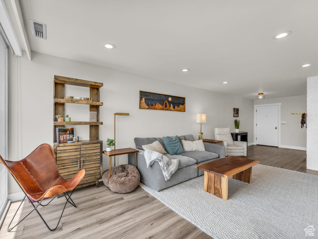 Living room with light wood-style floors and recessed lighting