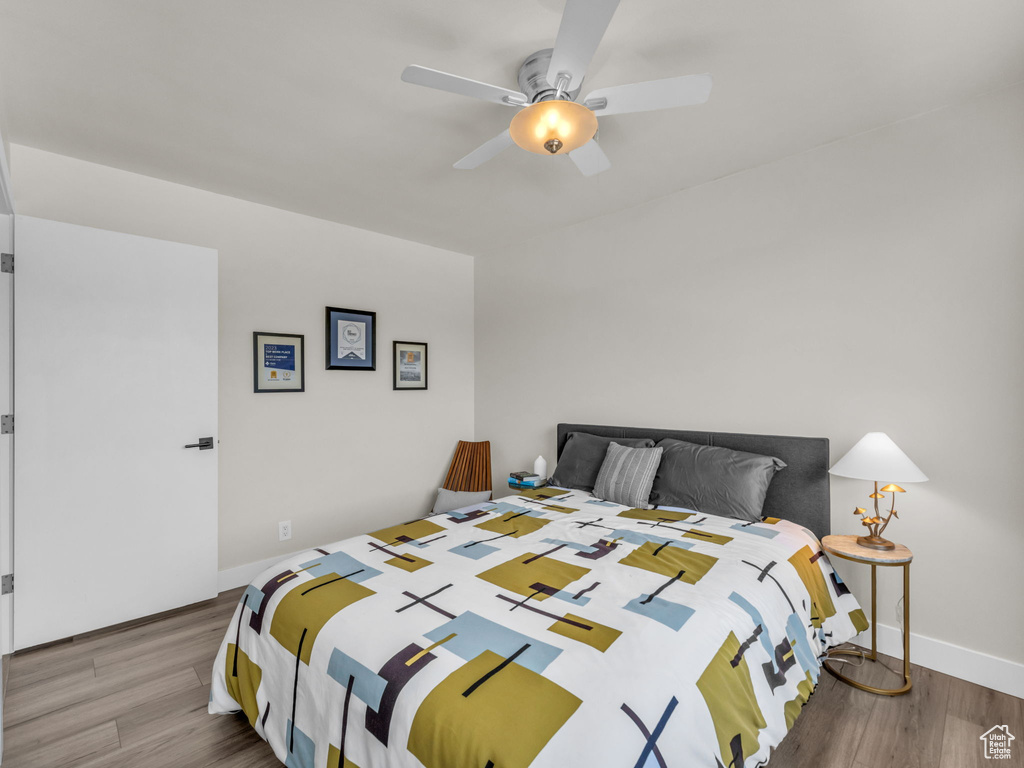 Bedroom with wood finished floors and ceiling fan