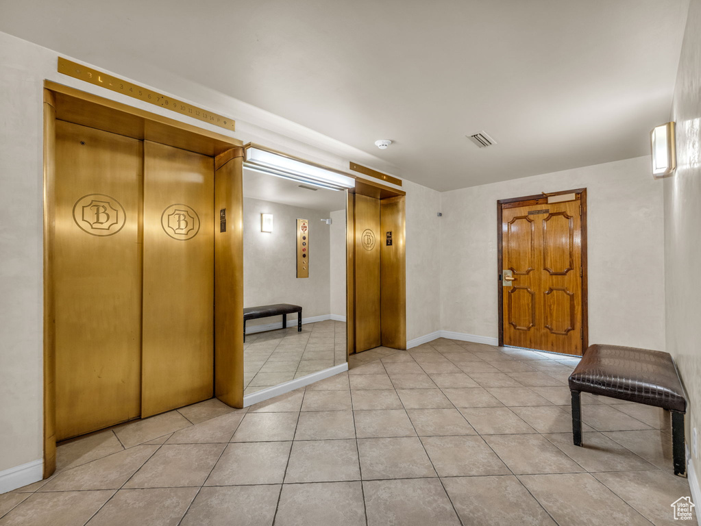 Below grade area featuring elevator and light tile patterned flooring