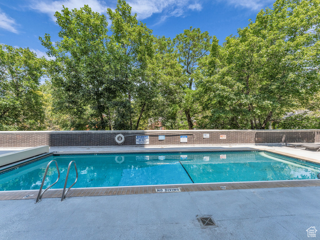 Community pool with view of wooded area