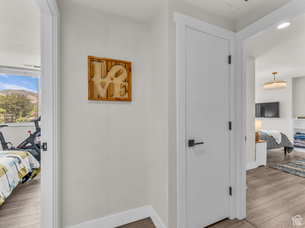 Corridor featuring wood finished floors and recessed lighting