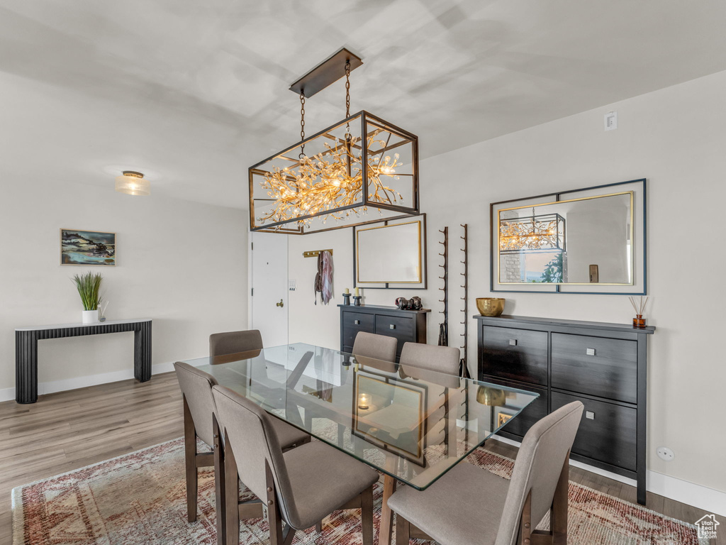 Dining room featuring wood finished floors and a chandelier