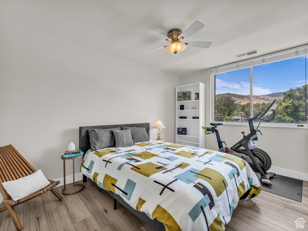 Bedroom featuring wood finished floors and a ceiling fan