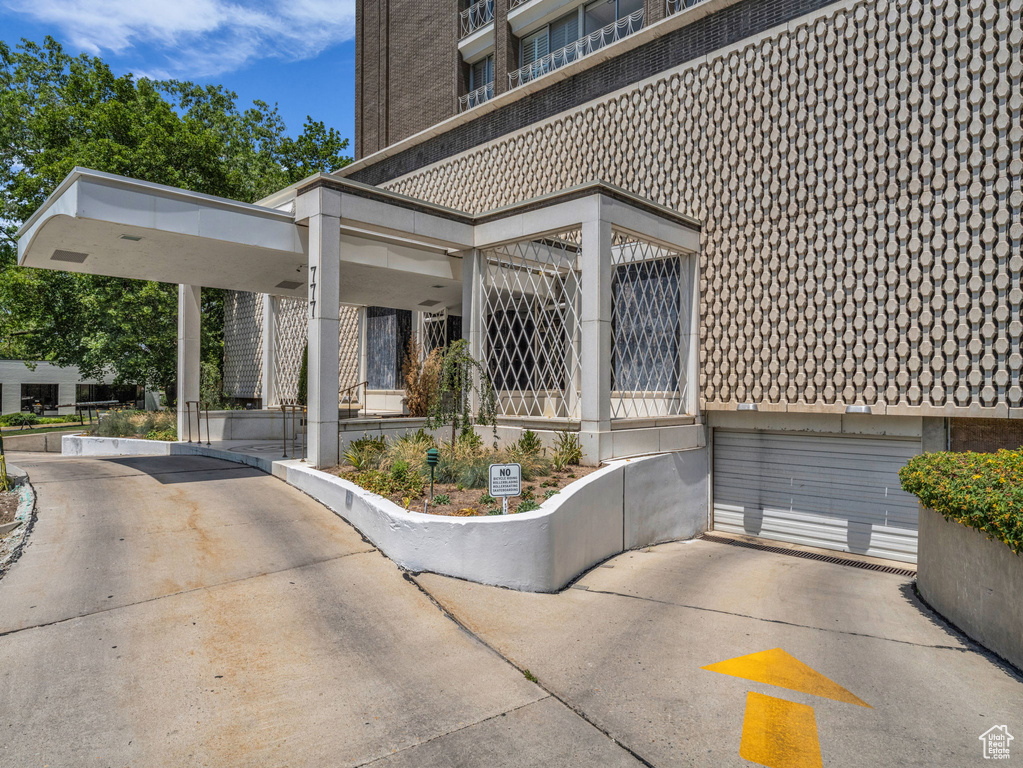 View of patio / terrace with a garage and driveway