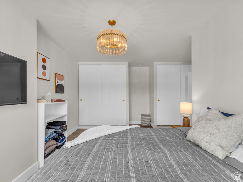 Bedroom featuring a chandelier and a closet