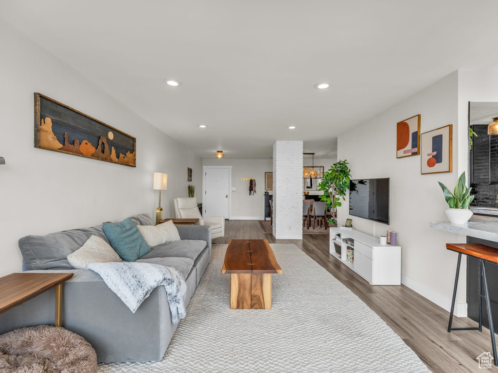 Living area with wood finished floors and recessed lighting