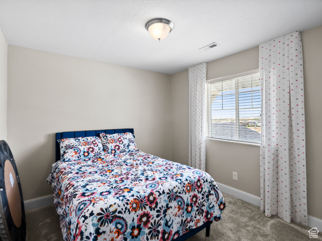 Bedroom with carpet flooring and baseboards