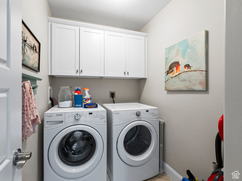 Washroom with cabinet space and washer and clothes dryer
