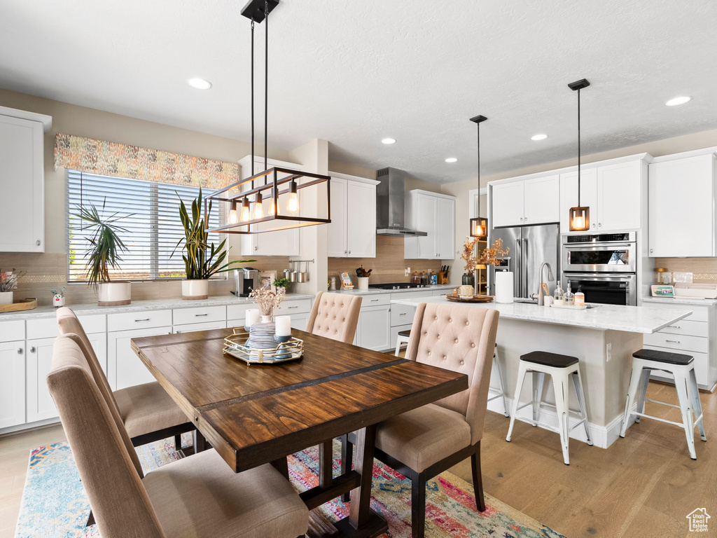 Dining space featuring recessed lighting and light wood finished floors