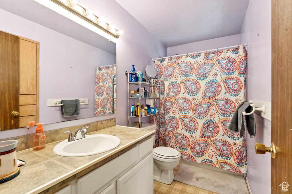 Full bathroom with vanity and curtained shower