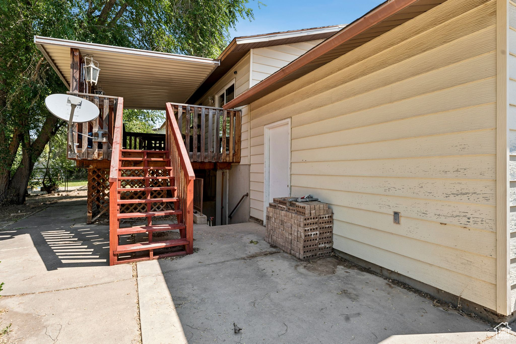 View of patio / terrace featuring a wooden deck and stairway
