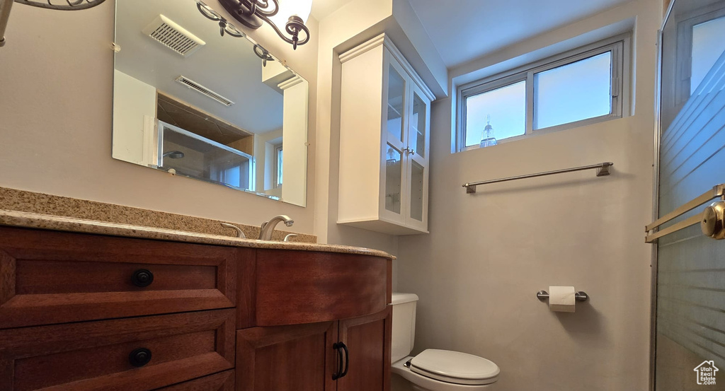Full bath with vanity and a shower with door