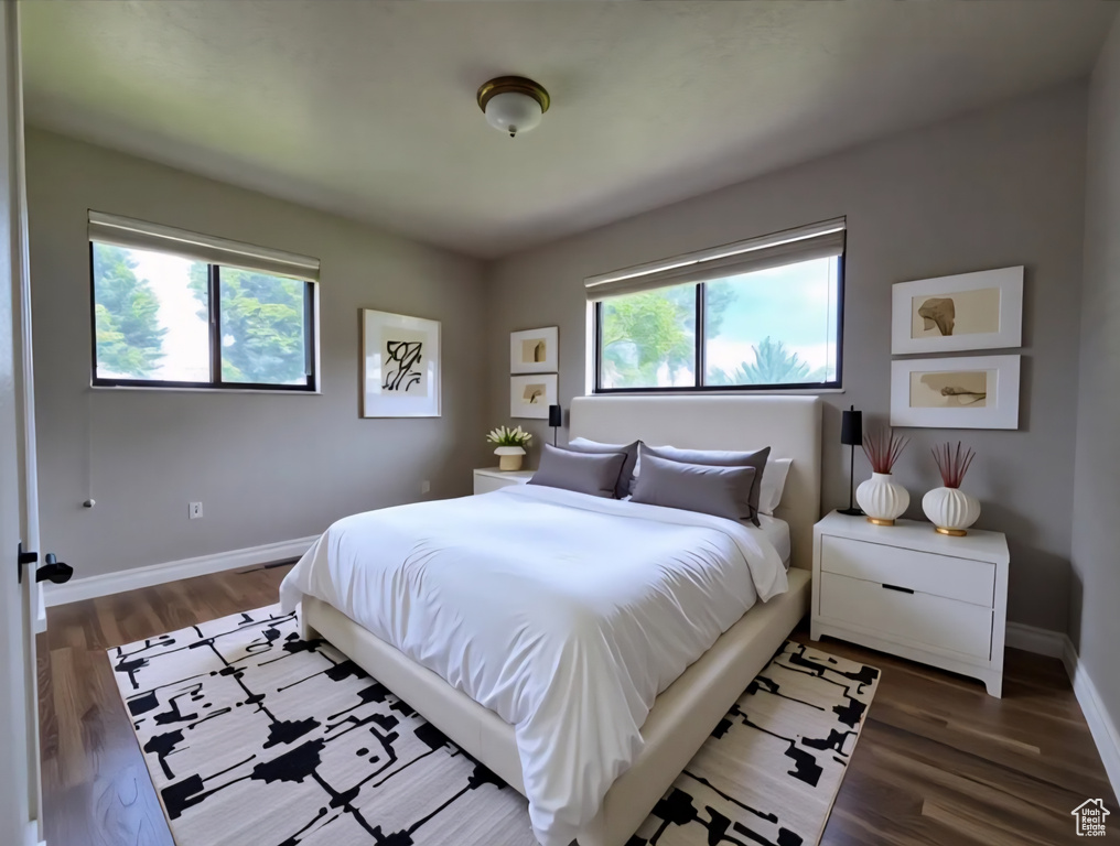 Bedroom featuring wood finished floors and baseboards