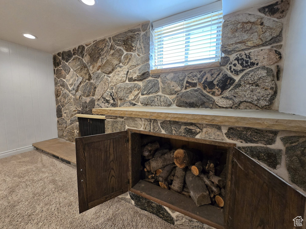 Detailed view of carpet floors and a large fireplace