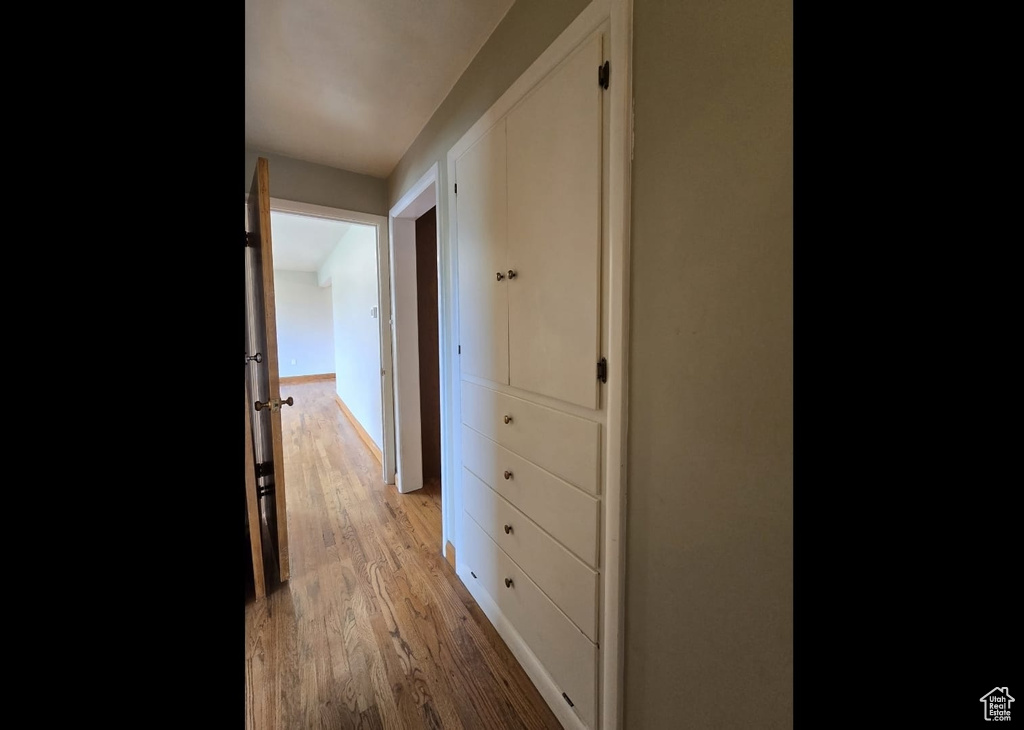Corridor with light wood-type flooring