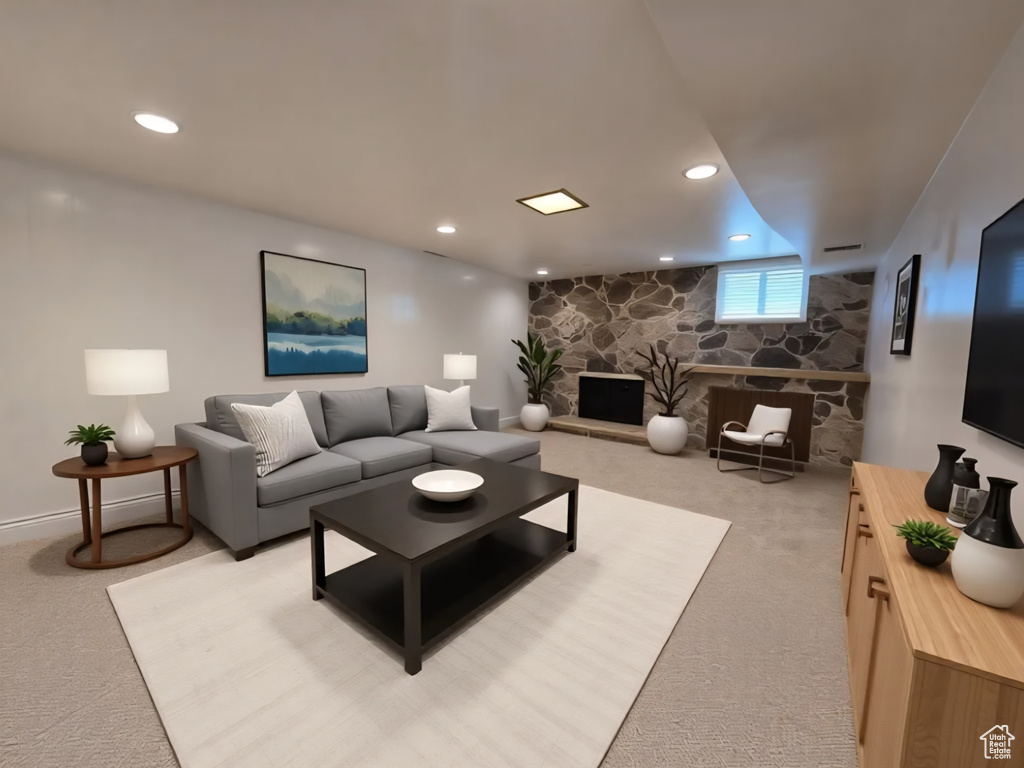Living area with light colored carpet, a fireplace, and recessed lighting