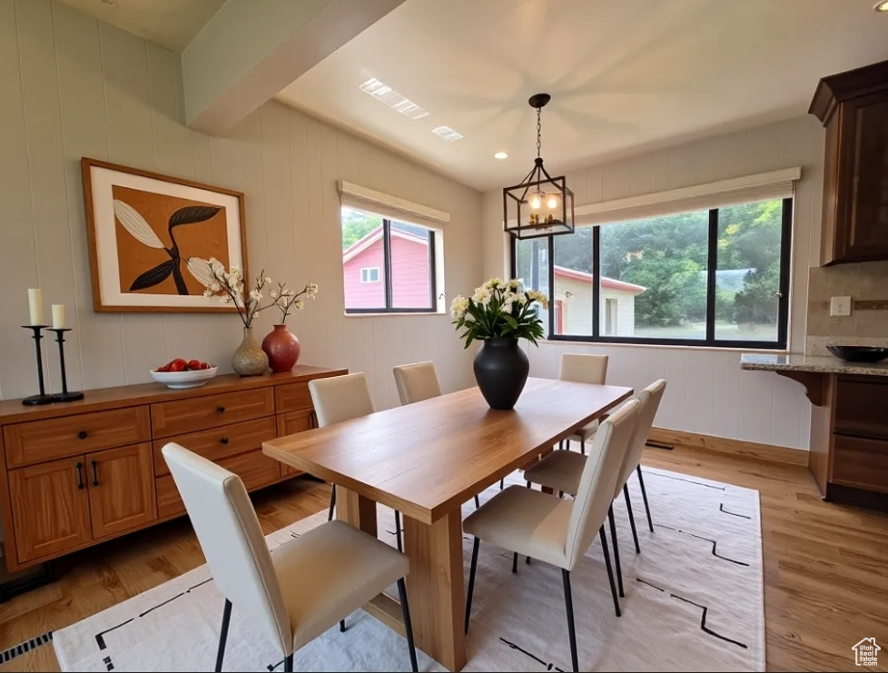 Dining room featuring light wood-style flooring and healthy amount of natural light