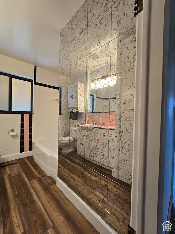Full bath with a bathtub, wood finished floors, and a shower