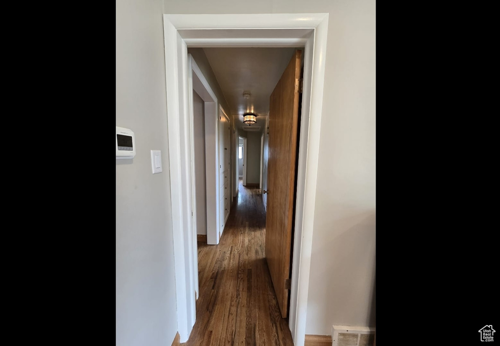 Hallway with wood-type flooring